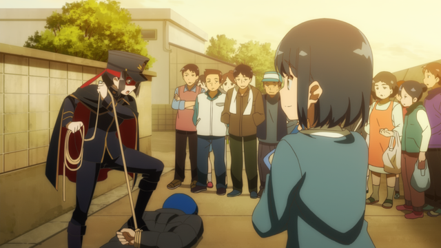 The masked lady apprehends a bad guy while a crowd looks at the spectacle.