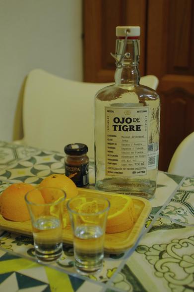 Bottle of mezcal Ojo de Tigre with orange and sal de gusano.