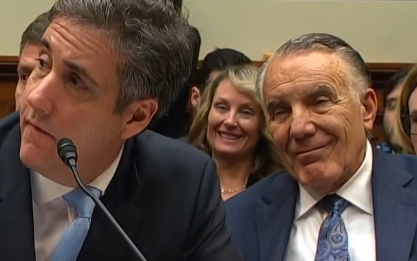 audience members smiling as Michael Cohen addresses Congress