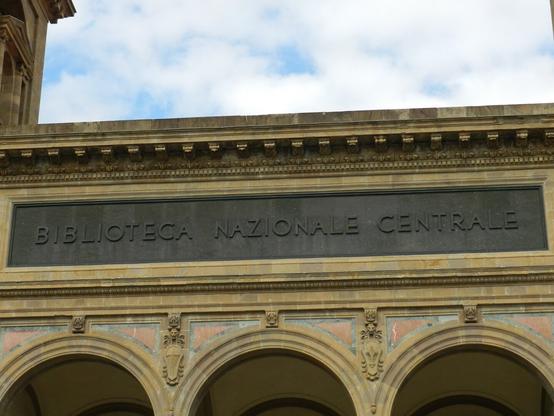 The image depicts a section of the Biblioteca Nazionale Centrale (National Central Library) in Florence, Italy. The title of the building is on a plaque in this image.