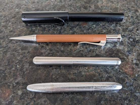 Closed display of:

LAMY AL-star black EMR Stylus with a felt tip

Faber Castell pencil

Kaweco Lilliput fountain pen 

Fisher Space Pen