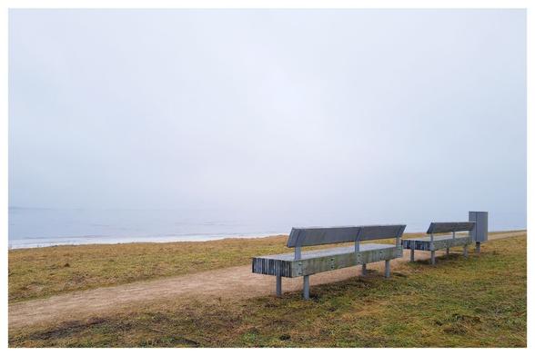 Two benches, fog and mist over river.