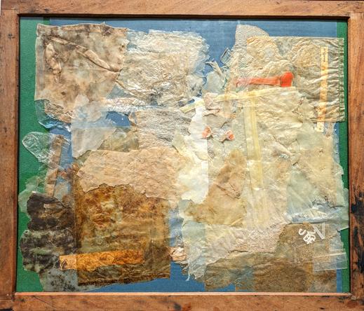 A large contact printing frame - wooden, with glass - containing pieces of plastic jetsam found on Matosinhos beach, Porto. They are layered randomly, almost totally covering a piece of cyanotype-coated paper. It is ready for exposure in the sun.