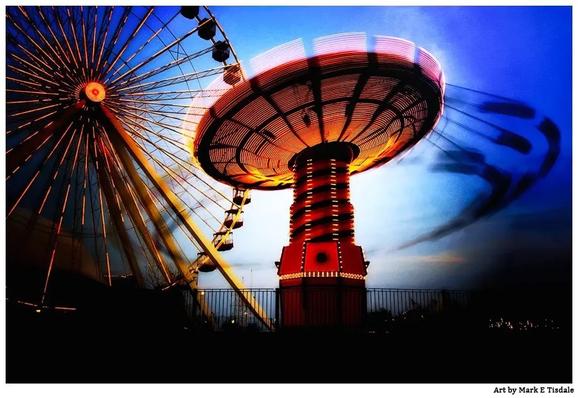 Photograph from Chicago's Navy pier. Shows a portion of a Ferris Wheel and the Wave Swinger in motion creating a blur.