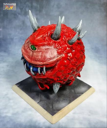 High angle photo of the front left of the Cacodemon sculpture.