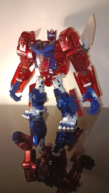 Primal Prime in robot mode stood on a dark glassy surface strongly lit from the left of the image.

A little insight into my process: this photo is a rescue from my reject pile as my camera doesn't capture his colours correctly. Tjat's why there's no photo's of any other modes...for now. Watch this space...