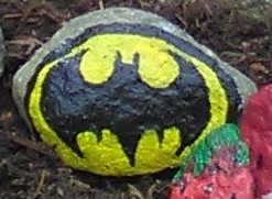 A batman logo painted on a fine ovalesque rock