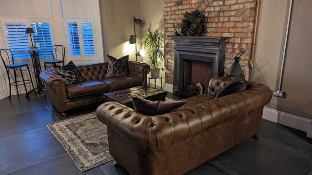 Comfort area by the fireplace with luxurious leather sofas