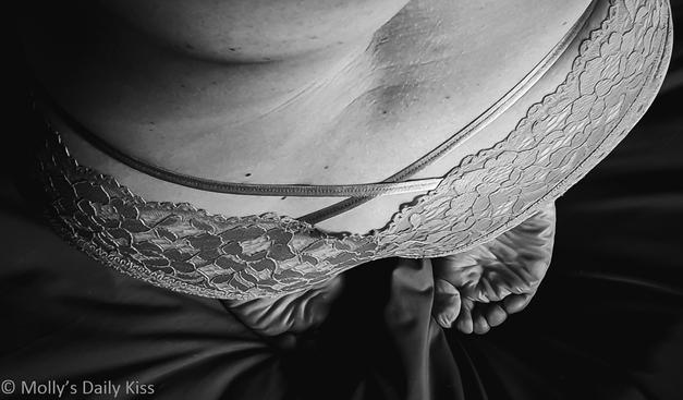 Black and White Side view of molly kneeling wearing lace knickers with ribbon ties across the top of her buttocks