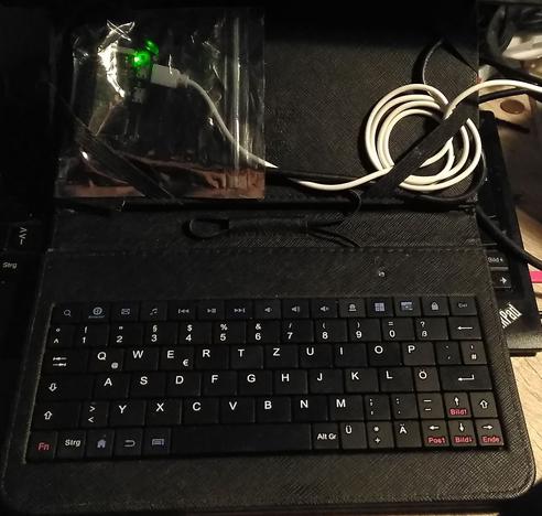 A Raspberry Pi Zero W with a USB-OTG Keyboard, a HDMI adaptor and cable as well as USB Power Supply being used as a desktop PC.