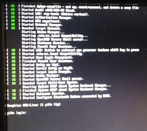 The same Raspberry Pi Zero W running Raspberri PiOS minimal and booting to a CLI login on a big LCD screen.