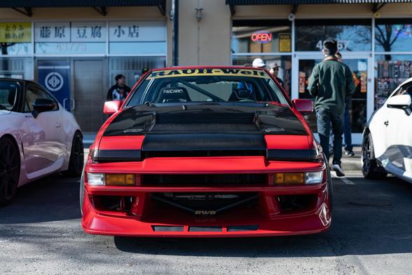 Front shot of a red Toyota coupe.