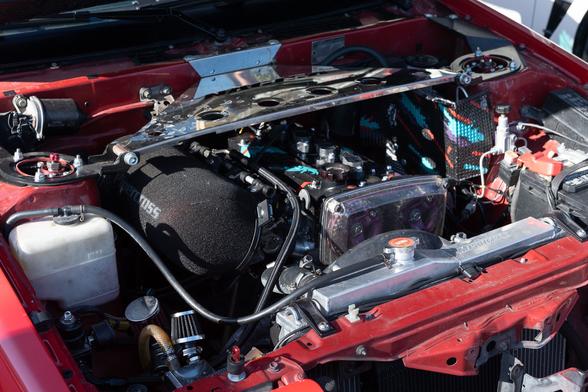 Engine bay of coupe with extensive mods.
