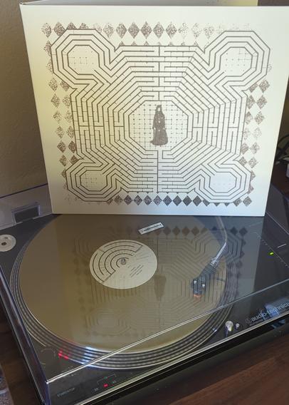 gold lp playing slowdive on audio-technica at-lp120 with gatefold album cover atop turntable dust cover