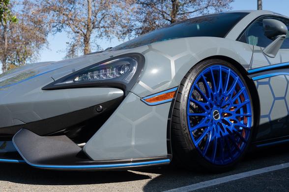 Detail of front end featuring large blue wheel.