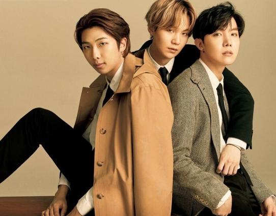 BTS rapline in suits and big coats looking at the camera. yoongi has his arms around namjoon and hoseok like he's holding them to him