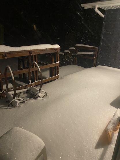 Heavy deep snow on a cedar wood deck at night