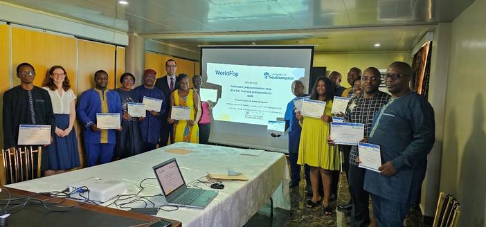 Workshop participants holding completion certificates