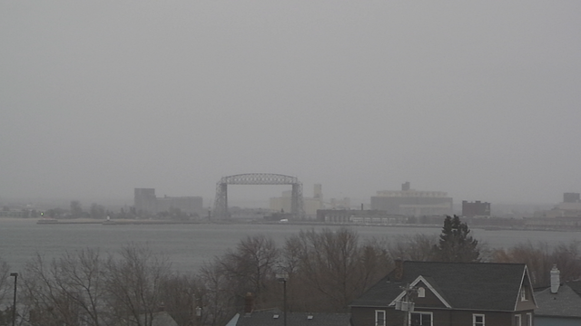 A view outside the KQDS TV station building towards the Aerial Lift Bridge and the Duluth-Superior Port at 4 p.m. on Tuesday, February 27, 2024.  It shows snow showers in the area with winds becoming blustery.