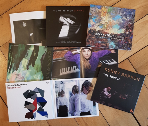 assembly of CDs by Richie Beirach, Denny Zeitlin, Marie Krüttli, Kenny Barron and Johanna Summer on wooden floor