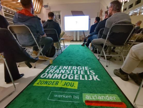Loper met slogan "De energietransitie is onmogelijk zonder jou. Werken bij Alliander"