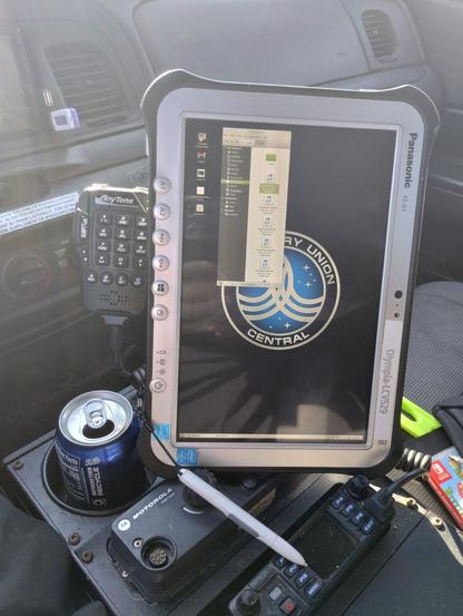 My Panasonic FZ-G1 tablet, leaning against a microphone mount, in the center console of my 2008 Ford Crown Vic ex-police car, also seen a Anytone radio, and part of a Motorola radio that was left in the car from the police department I got it from.