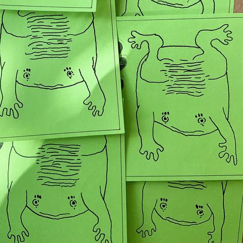 Ink drawings of some toads with their limbs outstretched.