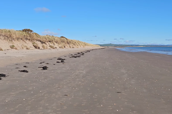 A picture of Sandhead beach, blue sky and sea.