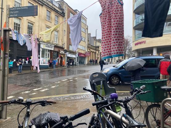 T-junction with bicycles parked above which line of children’s clothes