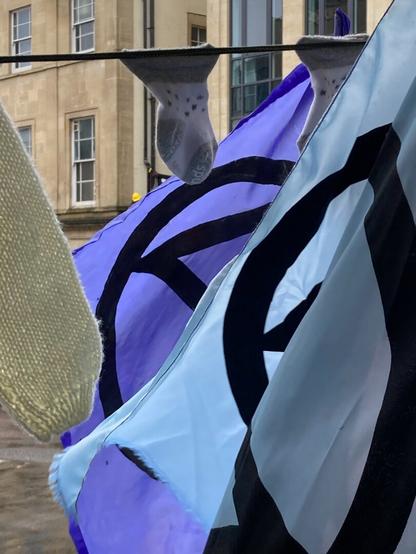 Flags caught by breeze, socks and jumper on line