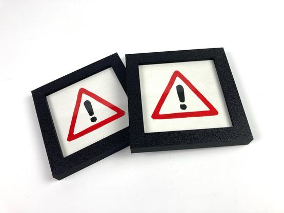 Two mini prints of a danger sign.