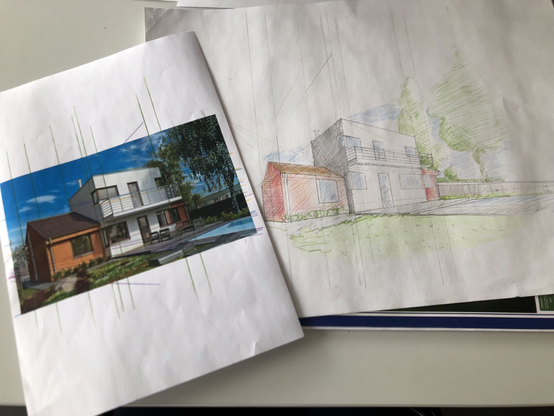 A photo of a house with perspective lines drawn onto it, lying on top of a drawing of the same house.