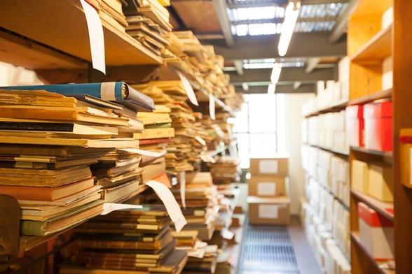photo - hard copy journals / papers on a library shelf