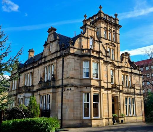 A large sandstone Victorian villa.