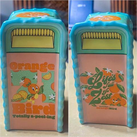 A collectible salt shaker designed to resemble the Orange Bird character, with text "Orange Bird Totally a-peel-ing" and "Life's Full of Zest The Original Orange Bird" on each respective side.