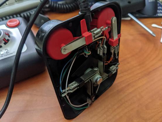inside of a competition pro joystick; it features metal leaf springs that press into each other to trigger a connection, instead of clicky switches. It's a lot like a Wico stick.