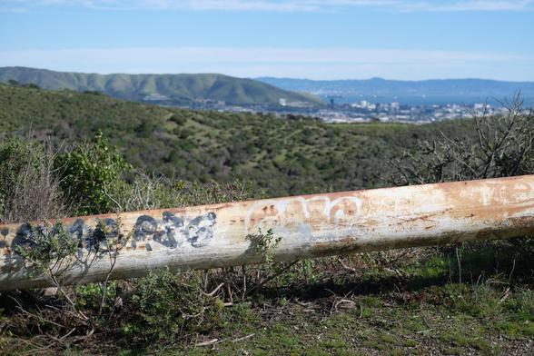 Old railings in front of some mountains. Sweeping views.