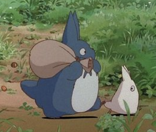 a screengrab from "My Neighbor Totoro" in which a little blue rabbit like creature holds a bag older its shoulder