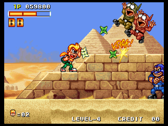 Scene 2-1 of Spinmaster. This takes place in a desert within Egypt. The player character, Johnny, is a blond guy with a pompadour hairstyle. He is currently standing on an elevated path, built similarly to the pyramids which can be seen in the background. Below the path is a patch of quicksand.

Johnny is throwing pairs of green shurikens, defeating a couple of goons who are dressed in green and red (the latter is able to throw knives). Upon hitting an enemy, a "KRAK!" text is shown, which is also the sound effect that plays.

Below, a large muscular goon in blue is patrolling.