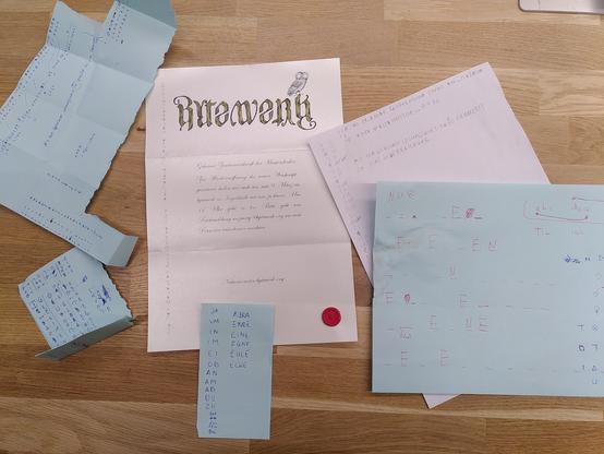 Die Einladung zur Neueröffnung des bytewerk Vereinsheim liegt auf einem Eichenholztisch. Um sie verteilt liegen diverse Schmierblätter mit Symbolen und zugeordneten Buchstaben. Das Einladungsschreiben ist auf leicht glänzemden Papier gedruckt und mit einem Wachssiegel in Form des bytewerk Sattelliten verziert. Der Linke Rand ist mit einer Reihe von Symbolen verziert. Der Einladungstext in einer Handschrift-Font lautet: "Geheime Zusammenkunft der Meisterdenker: Zur Wiedereröffnung des neuen Weishauptquartiers laden wir euch ein, am 9. März im bytewerk in Ingolstadt mit uns zu feiern. Um 17 Uhr geht es los. Bitte gebt uns Rückmeldung an party@bytewerk.org wie viele Personen teilnehmen.
Näheres unter bytewerk.org"