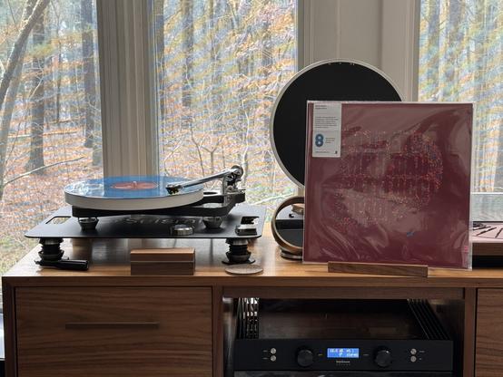 Chris Potter / Brad Mehldau / John Patitucci / Brian Blade - Eagle’s Point

Maroon cover with an open-quote in multicolored confetti. The artists last names are in the quote in the background color. A small teal eagle is at the lower right.

The blue streaked LP plays on a Rega turntable to the left.