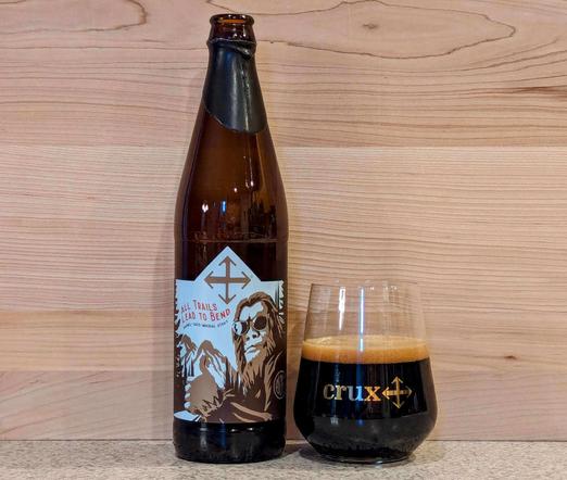 A bottle and glass of All Trails Lead to Bend Barrel-Aged Imperial Stout from Crux Fermentation Project of Bend, Oregon