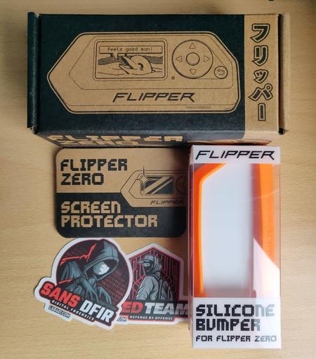 Flipper Zero, Orange Silicone Bumper, Screen Protection and some sticker.