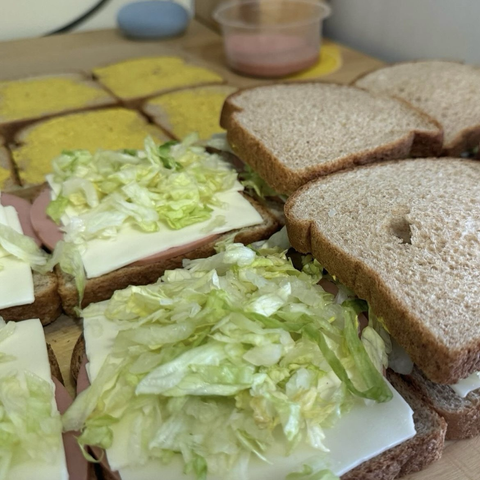Some bologna cheese and lettuce sandwiches.