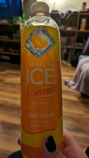 Bottle of sparkling ice brand sparkling water in orange starburst flavor