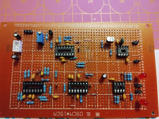 top side of the fully populated perfboard. power connector is at the left, key board connector top left, CV outputs on the right side, and the gate and trigger outputs with LEDs to the bottom right