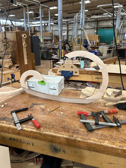 Three parts of one side of the kneeling chair are glued up.