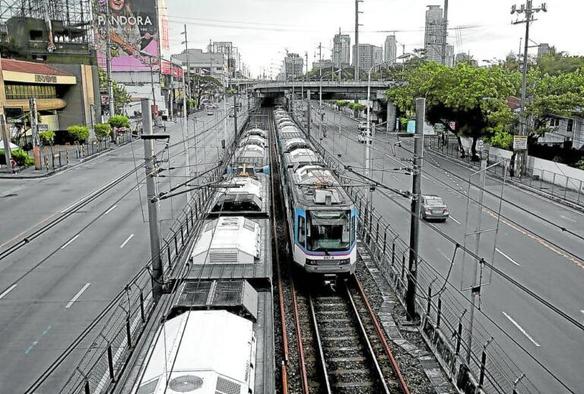 A view of the MRT3 rail transit in the city. Two MRT trains are navigating in opposite directions.