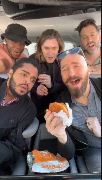 VoicePlay (Geoff Castellucci, Layne Stein, Eli Jacobson and Cesar De La Rosa) and J.None in a car singing about a spicy chicken sandwich which a couple of them look ready to grab out of Eli's hand and run away with.