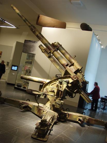 Housed in a museum, this WWII German artillery piece points its barrel towards the sky